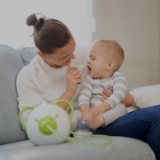 A little baby boy and his mother with the innovative Nosiboo Pro Electric Nasal Aspirator